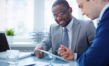 Two businessmen using a tablet device