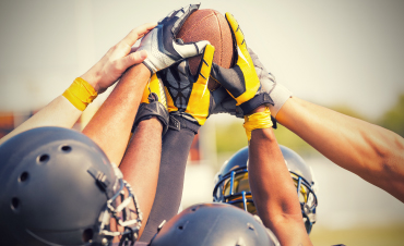 Football players in a team huddle